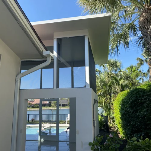 An outside view of an insulated aluminum roof for an outdoor patio next to a pool.